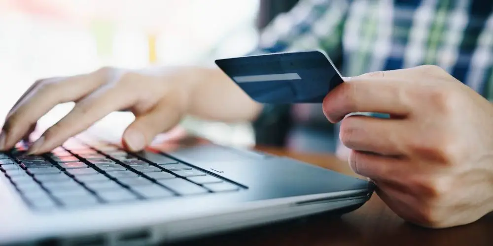 member checking transactions of UKRFCU Visa credit card on laptop