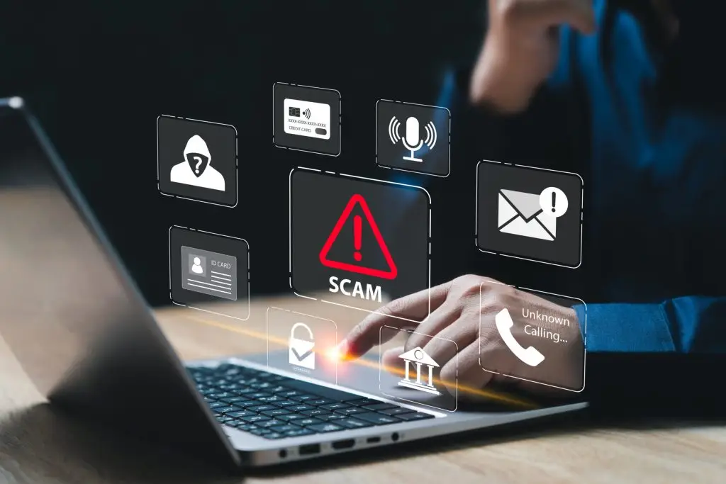 Fraud and scam icons floating above a laptop