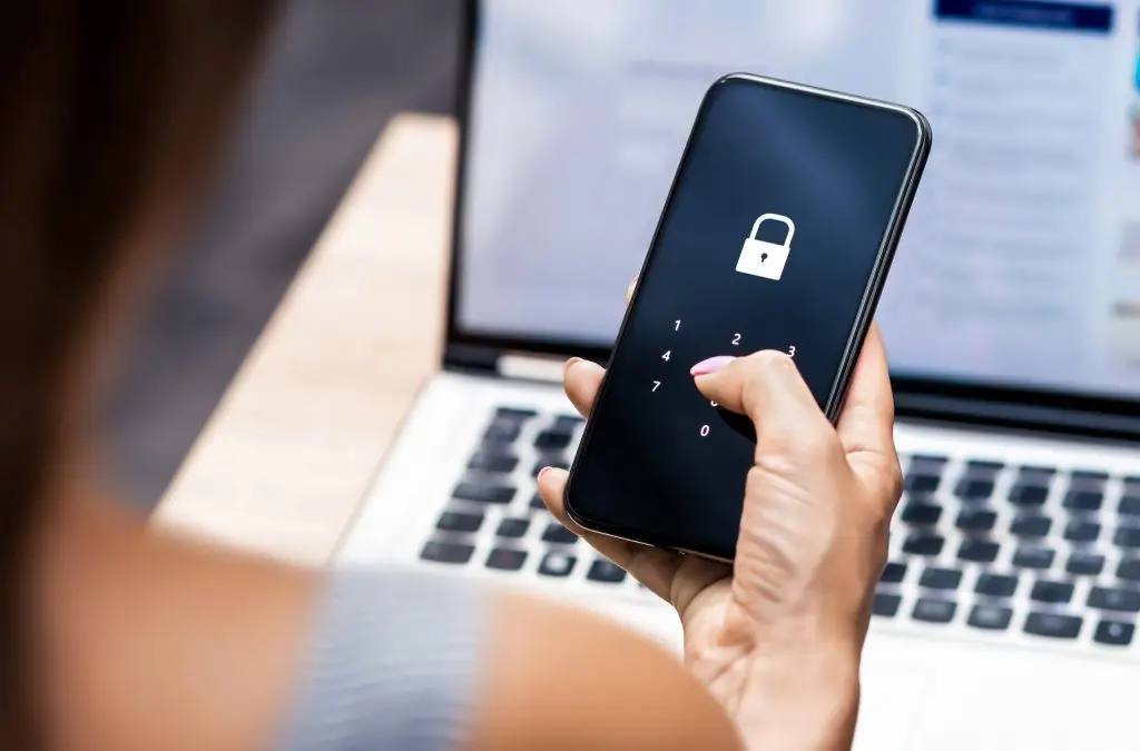 Closeup of someone holding a phone with the passcode screen showing