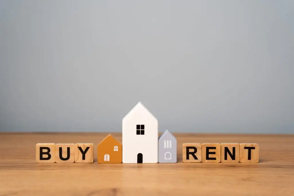 Blocks spelling "Buy" and "Rent" around a house