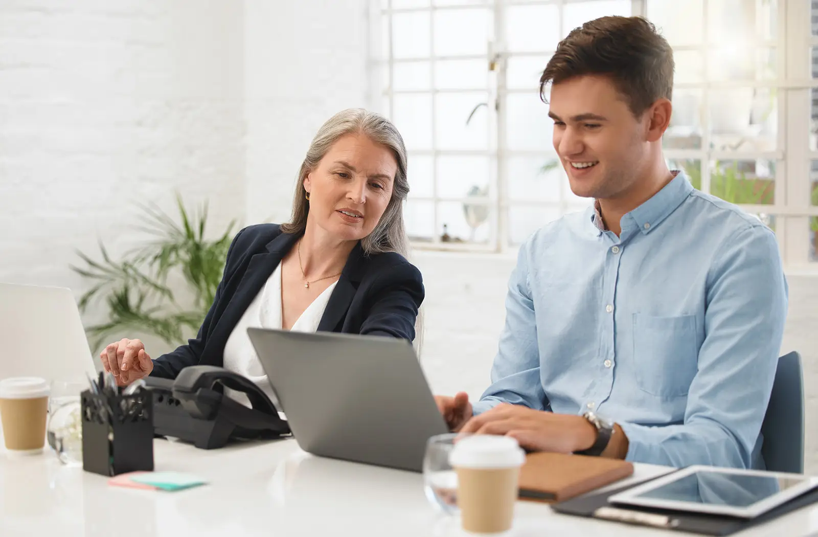 Two business people looking at a laptop together