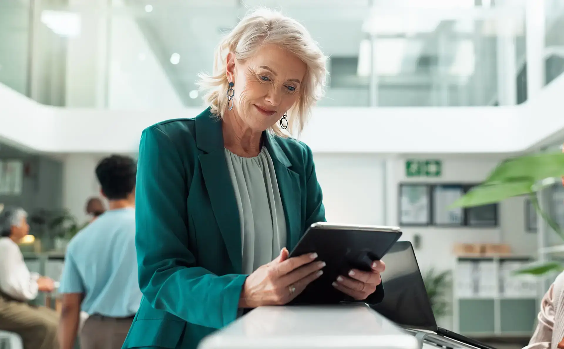 Woman in a credit union using a tablet