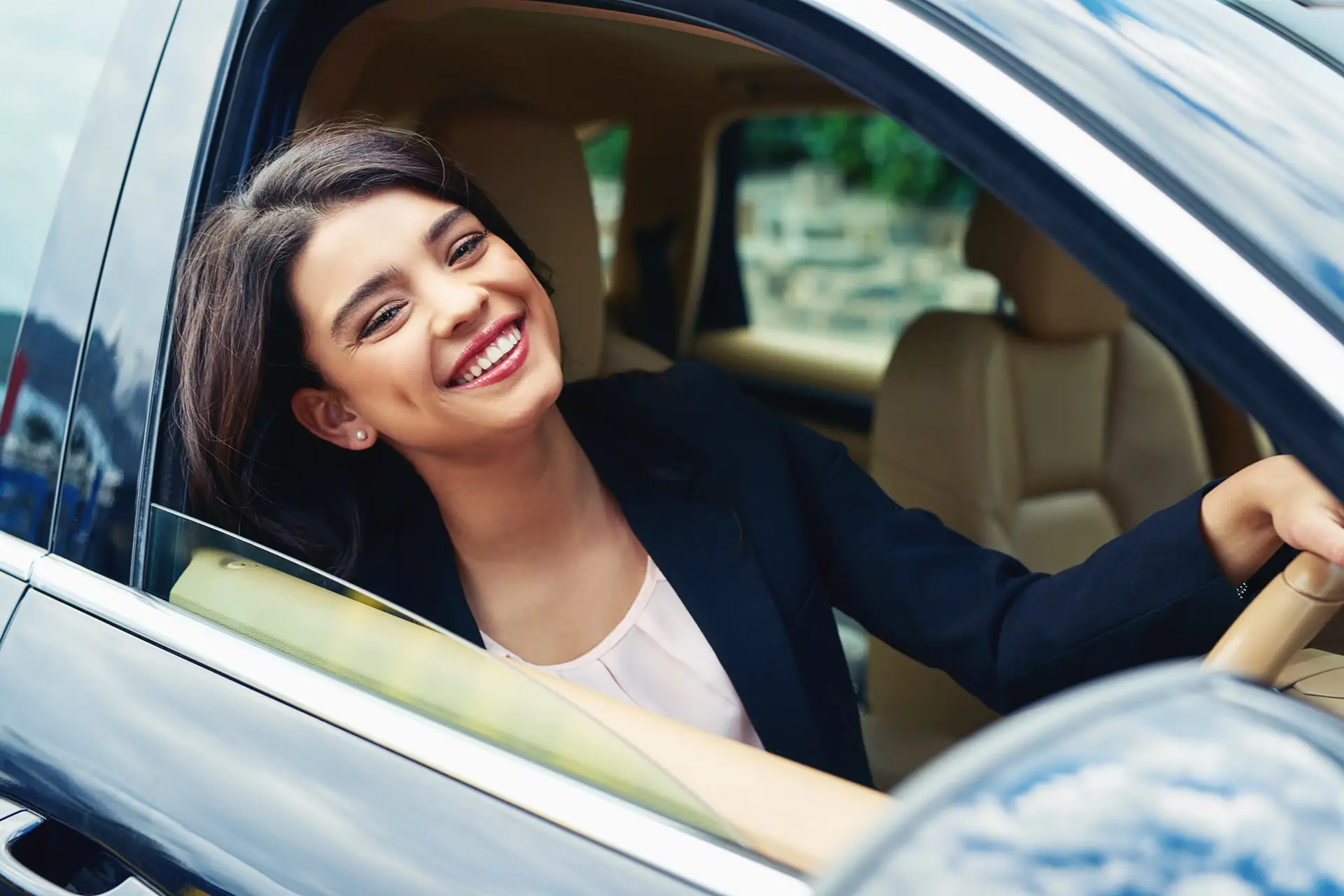 Woman smiling while driving a car