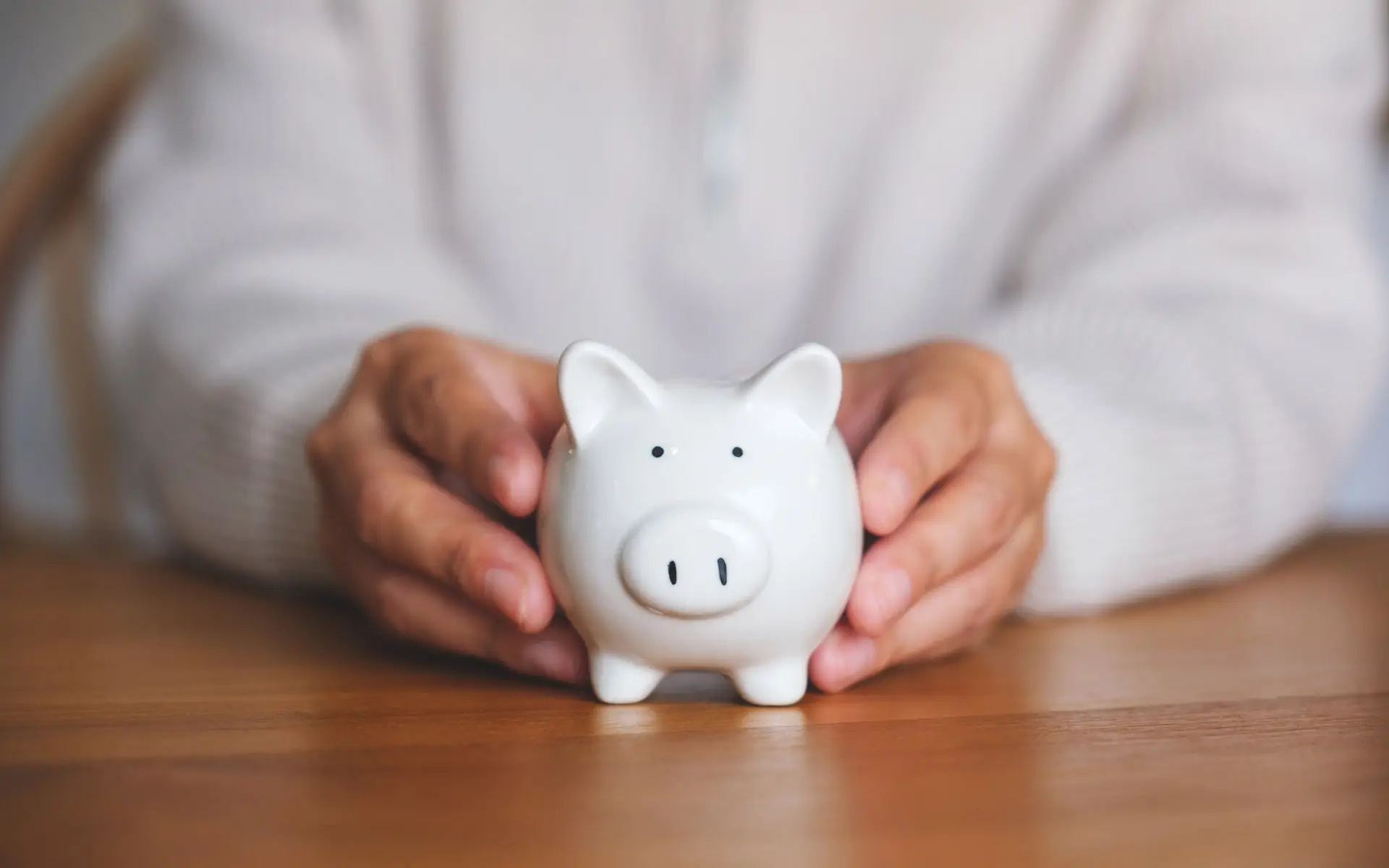 Closeup of hands holding a piggybank