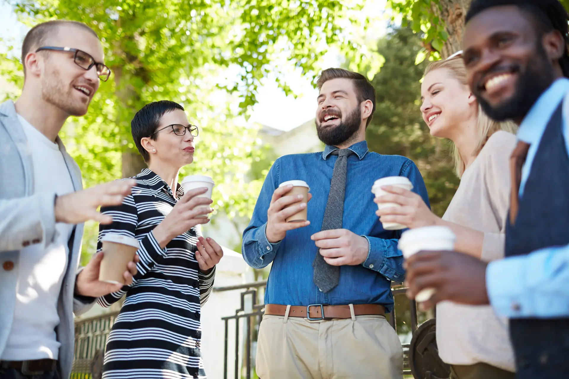 Colleagues enjoying coffee together outside