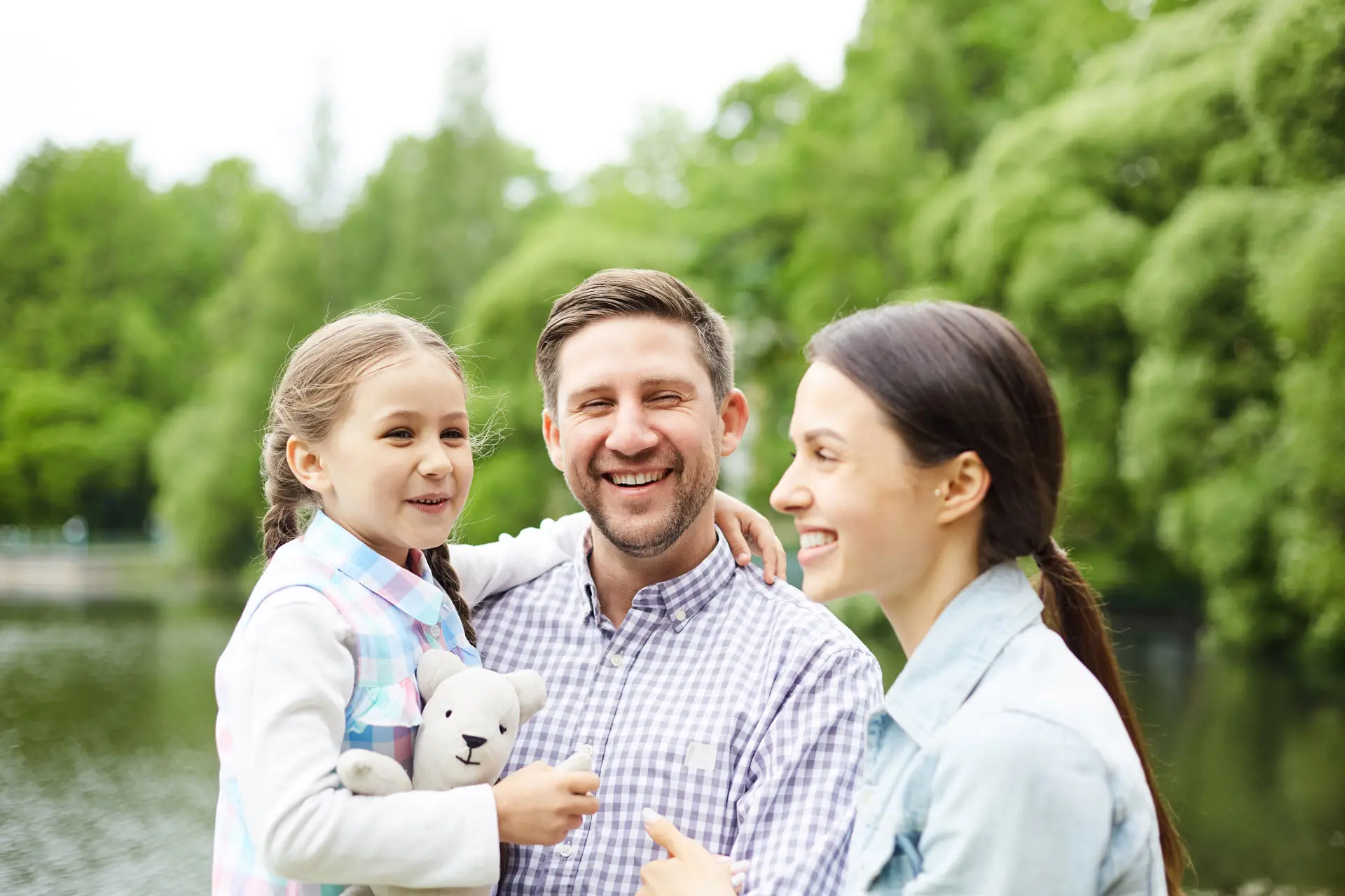 Family smiling in the park