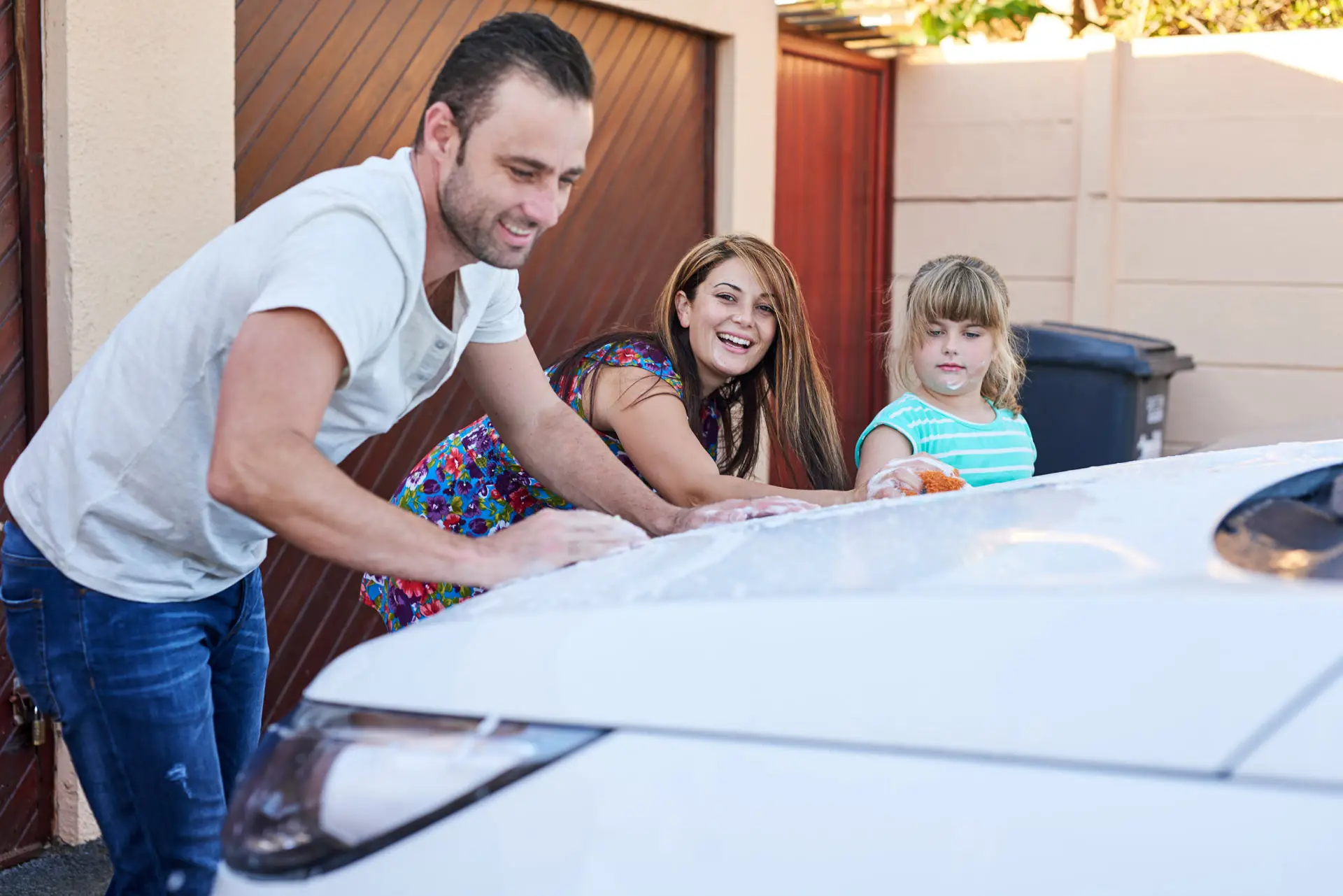 Family washing a car together