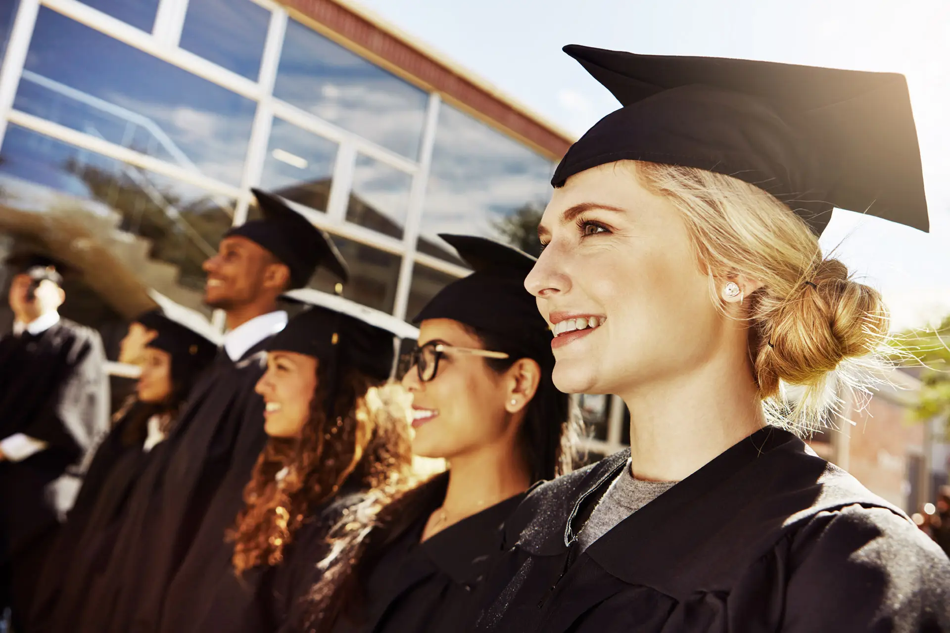 A group of students in caps and gowns lined up for graduation