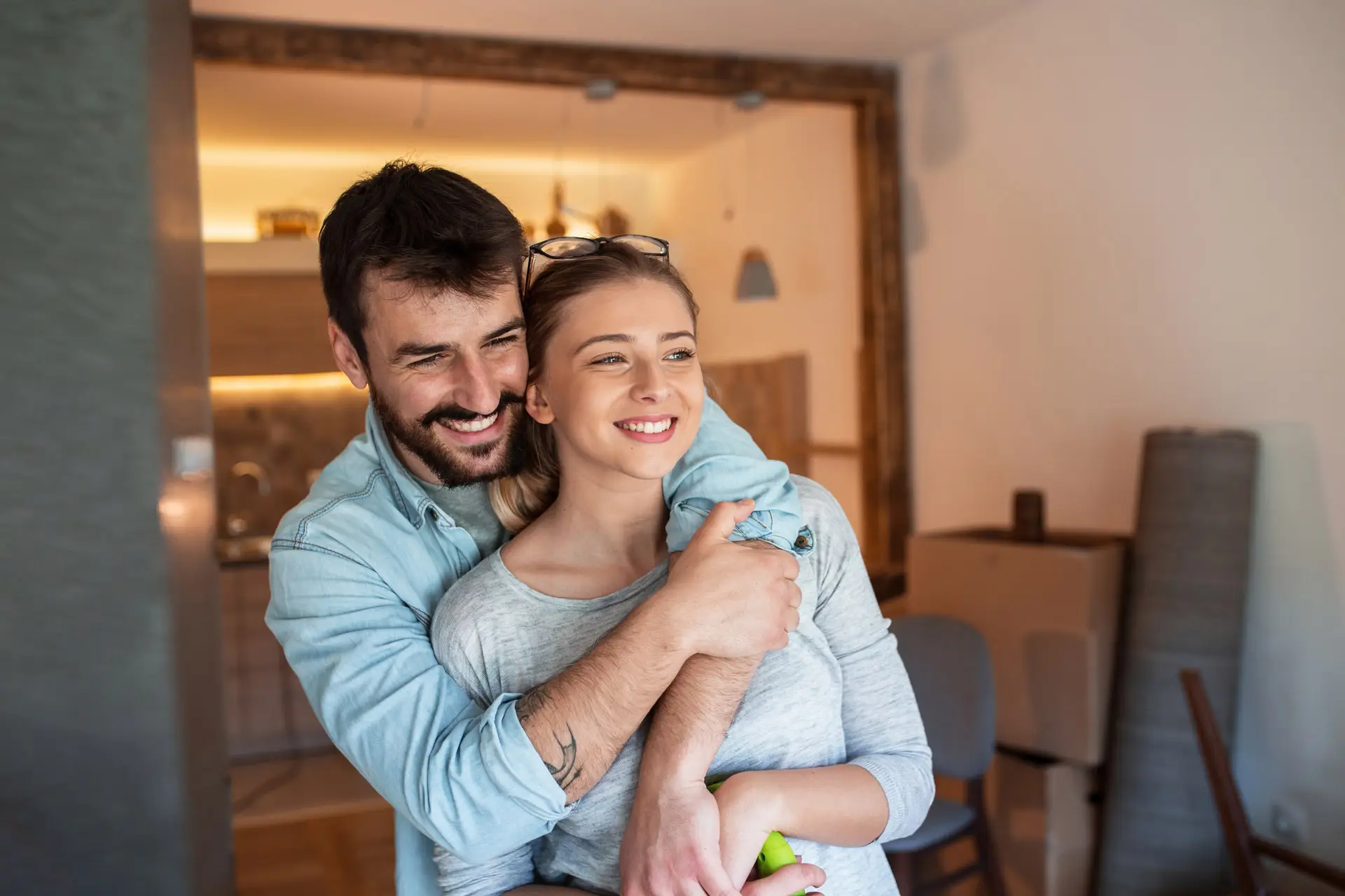 Couple embracing as they look out a window