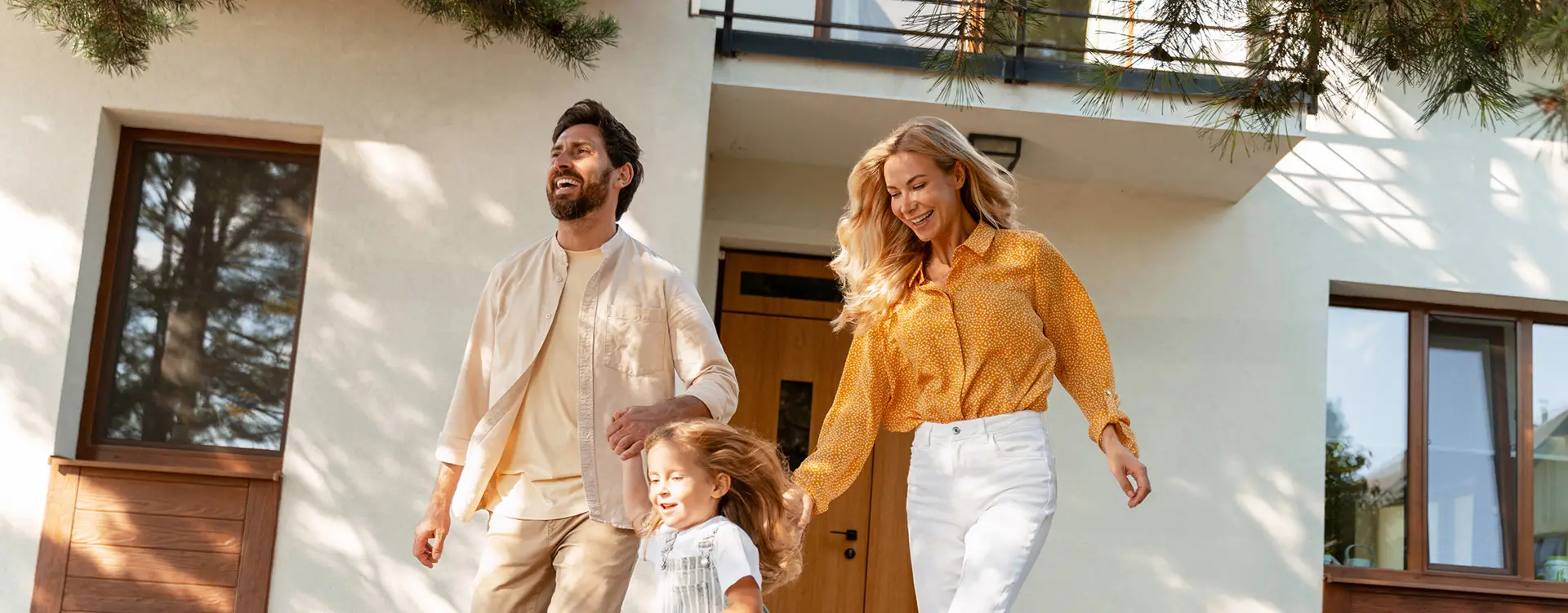Family smiling as they exit their home