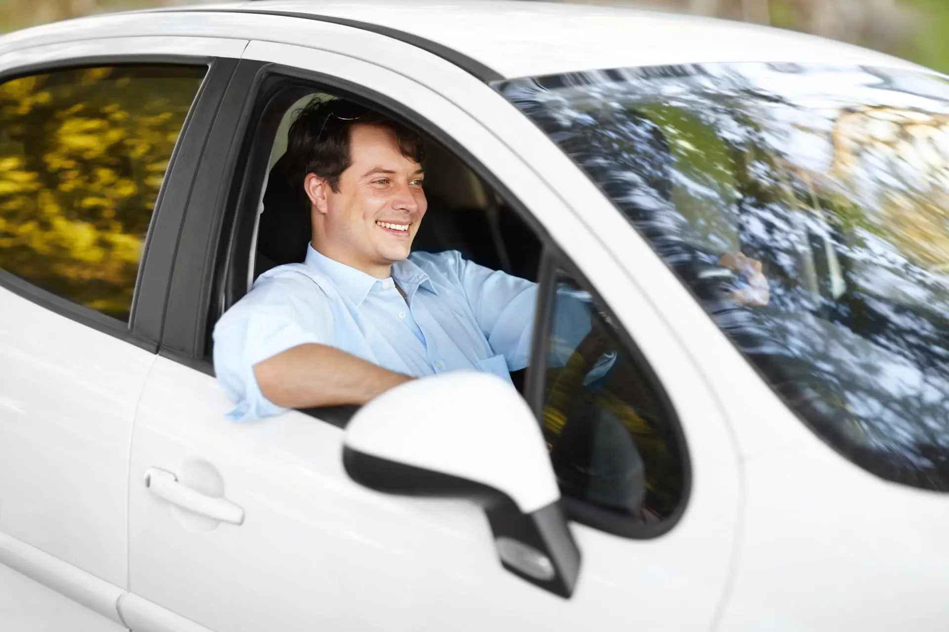 Smiling man in a car