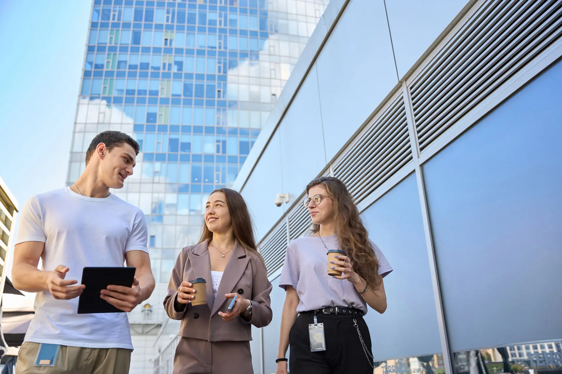 Three business people walking and talking