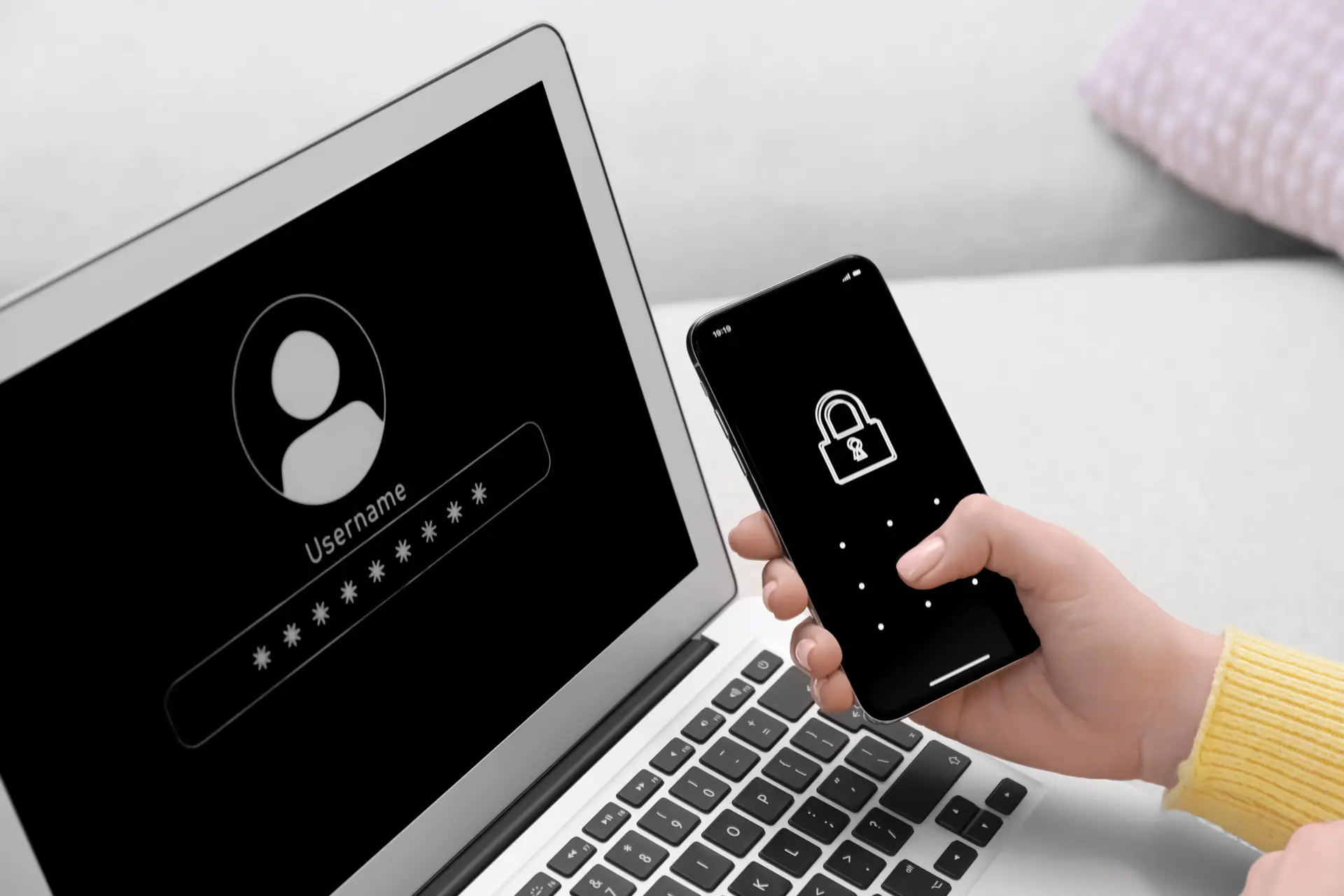 Closeup of a phone and a laptop with authentication screens