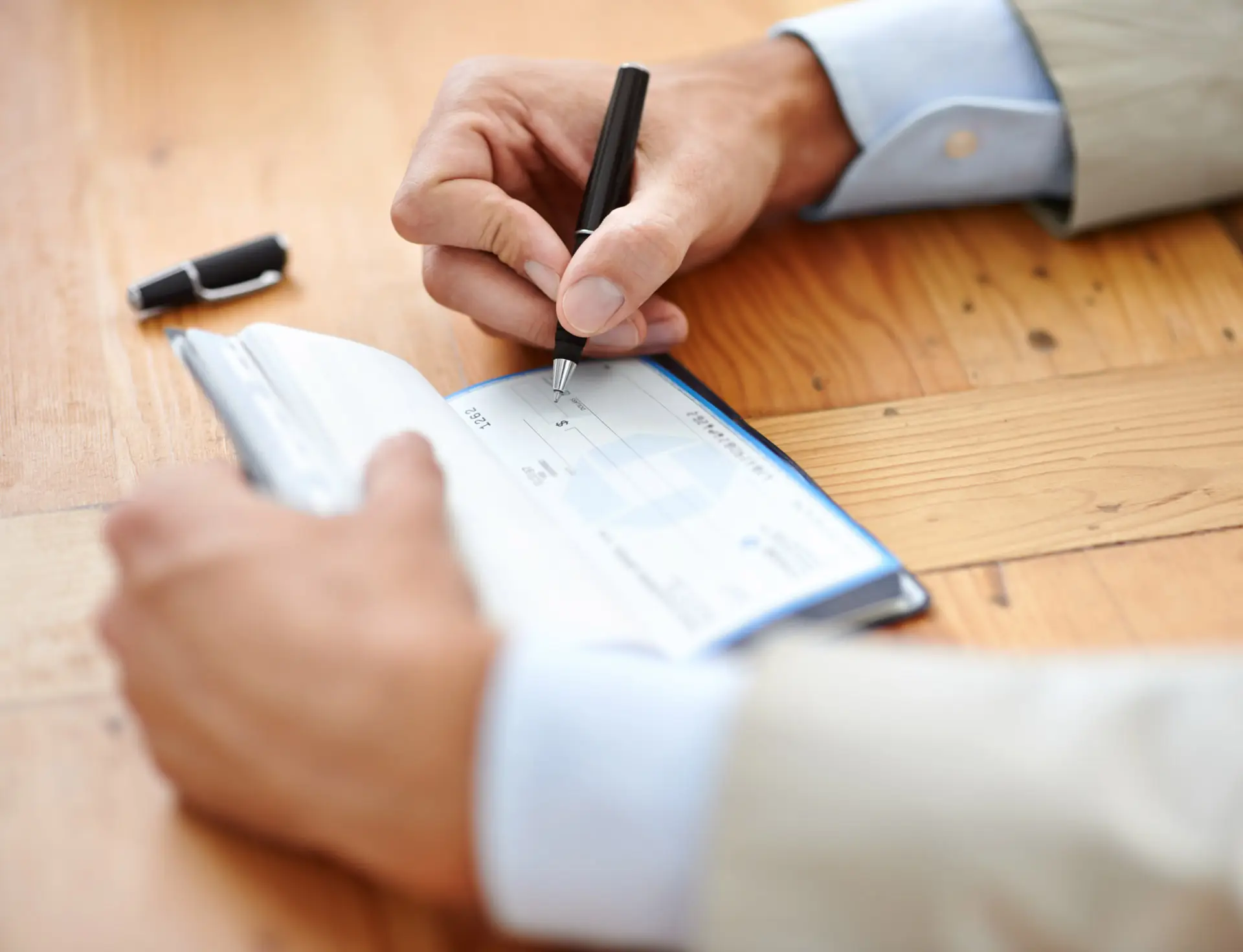 Closeup of someone writing a check